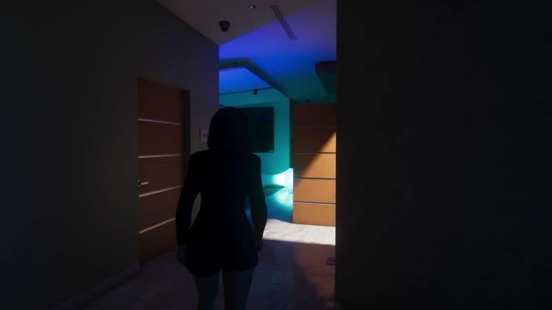 A woman with short dark hair, seen from behind in silhouette, walks along a dim corridor towards a room lit in blue and teal.