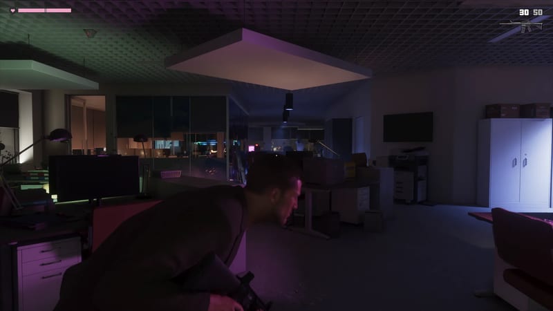 Jason Duval crouches with a rifle behind office desks in a dark, open-plan office lit in purple and green.