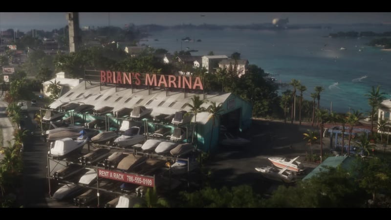 Brian's Boat Works & Marina, with boats stacked on racks beneath a large red rooftop sign, beside a turquoise bay lined with palm trees.