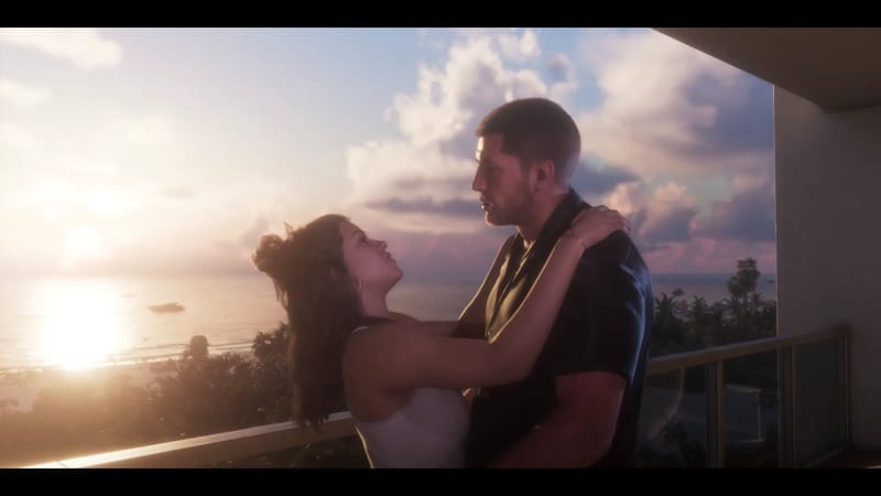 A man and a woman embrace on a hotel balcony at sunset, with the sea and palm trees behind them.