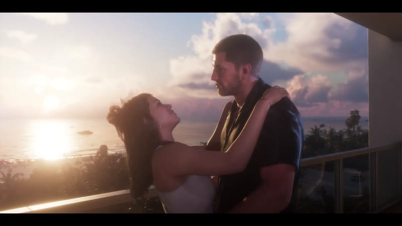A man and a woman embrace on a balcony at sunset, with the sea, palm trees and a glowing sky behind them.