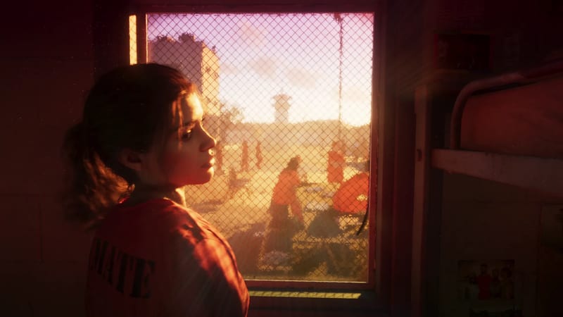 Lucia Caminos, in an orange inmate top, looks aside in a cell beside a mesh-covered window overlooking a prison yard at sunset.