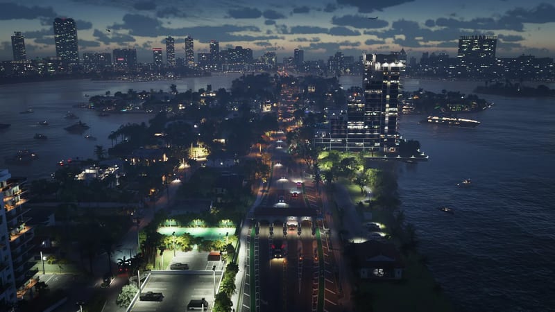 Aerial view at dusk of a causeway with a toll plaza and traffic, crossing waterside islands towards the lit skyline of Vice City.