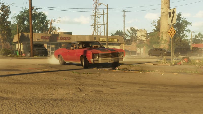 A red Declasse Tulip with a black bonnet stripe turns on a dusty road past a pawn and gun shop, with a faded sign in the background.