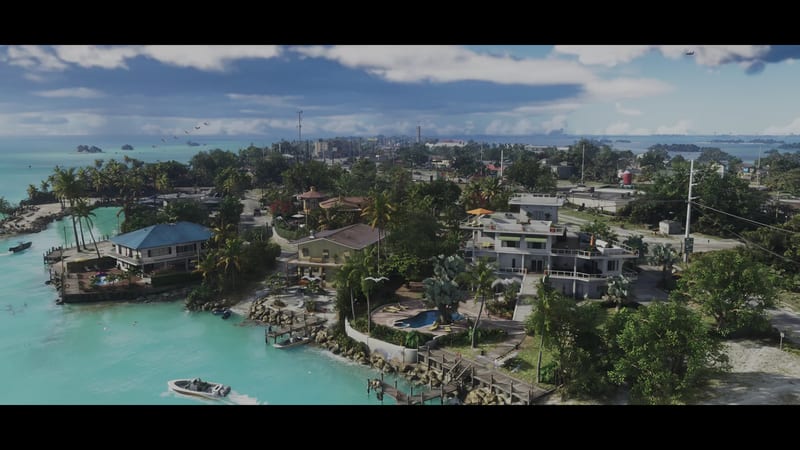 Aerial view of waterfront houses with a pool and wooden jetties on turquoise water in the Leonida Keys, with boats and palm trees under a cloudy sky.