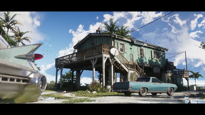 A shirtless man crouches on the roof of a green stilted wooden house beside a teal Vapid pickup, under a bright blue sky with palm trees.