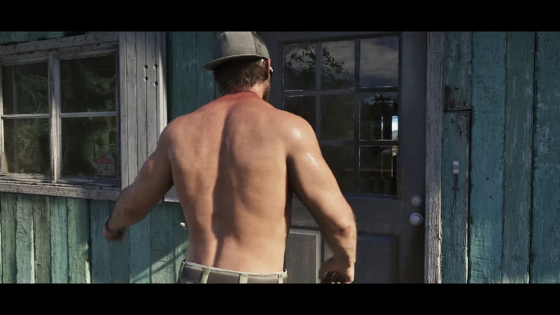 Shirtless Jason Duval, seen from behind in a grey cap, walks towards a dark door on a weathered teal wooden building in bright sunlight.