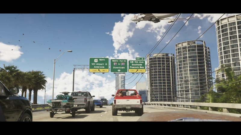 A red and white pickup truck leads traffic on a Vice City highway beneath green exit signs, with a jet flying low over tall round towers.