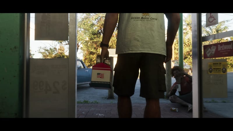 A man in a pale Leonida Marine Center T-shirt and cargo shorts, seen from behind, holds a six-pack of beer outside a shop as a seated man looks on.