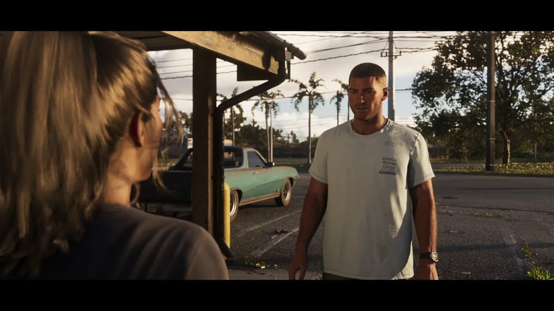 A short-haired man in a pale shirt faces a woman seen from behind, in a car park with a battered green car and palm trees at golden hour.