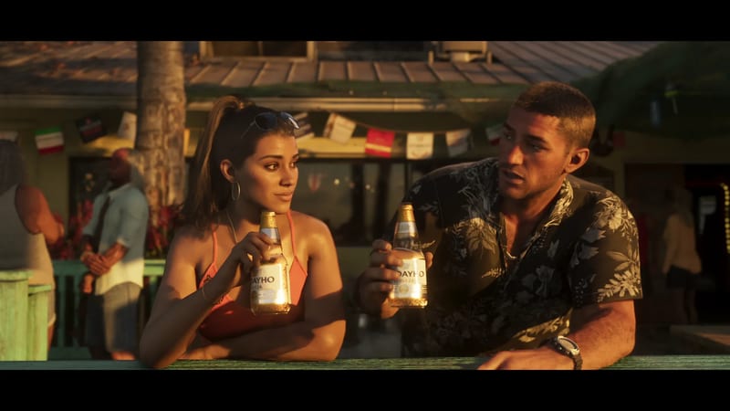 Lucia Caminos and Jason Duval lean on a green wooden bar rail holding beer bottles, in warm low evening sunlight outside a beach bar.