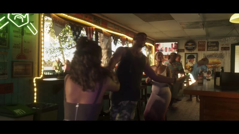 A man in a dark vest and camouflage shorts dances with two women inside a busy, sunlit beach bar decorated with bunting and fairy lights.