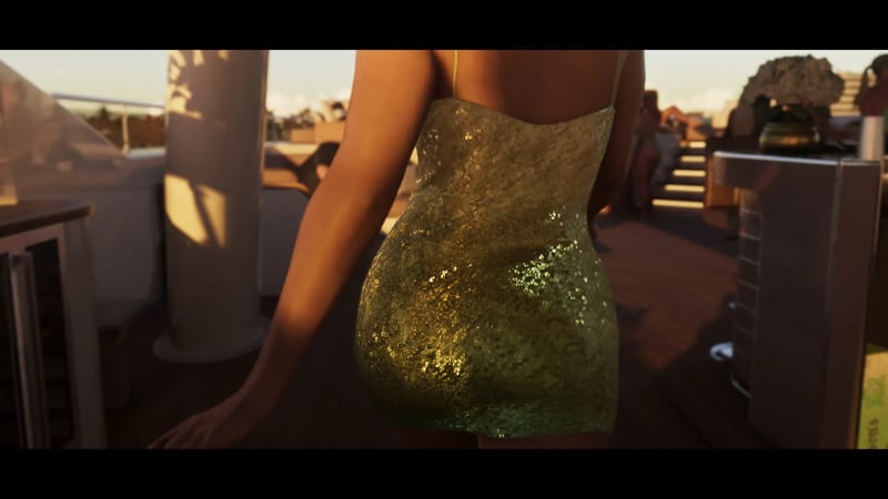 A woman in a short gold sequinned dress is seen from behind on a sunlit rooftop terrace with a wooden deck, steps and seating.