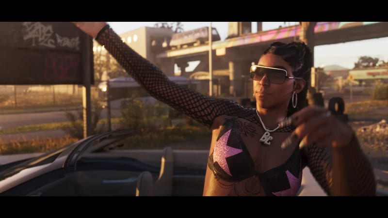A woman in sunglasses, a fishnet top and a pink star bikini top stretches one arm out beside a convertible, with a flyover and train behind her at golden hour.