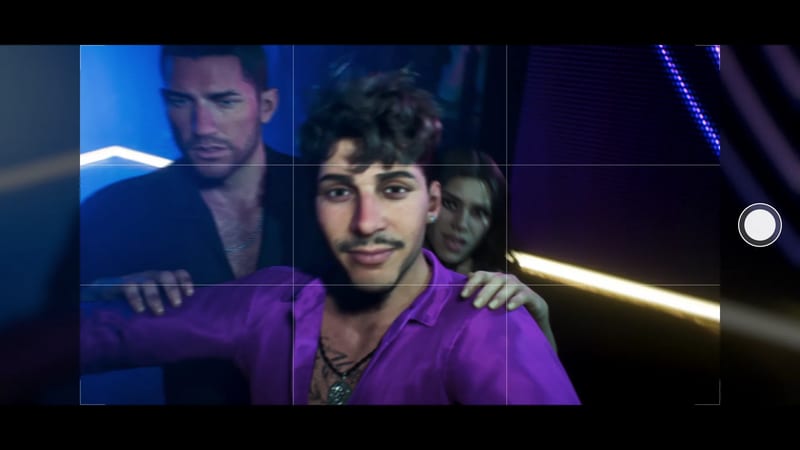 A smiling young man in a purple shirt takes a selfie in a neon-lit club, with a bearded man and a woman behind him.