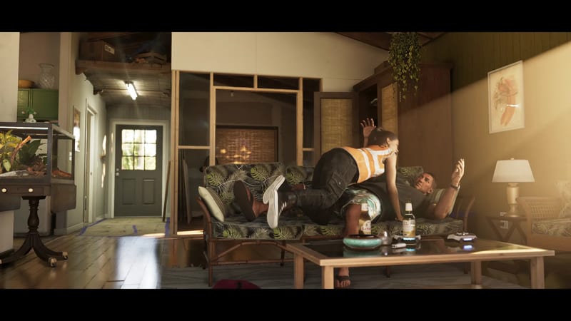 A woman in an orange hi-vis vest and dark trousers leaps over a sofa towards a man lying on it, in a sunlit living room.
