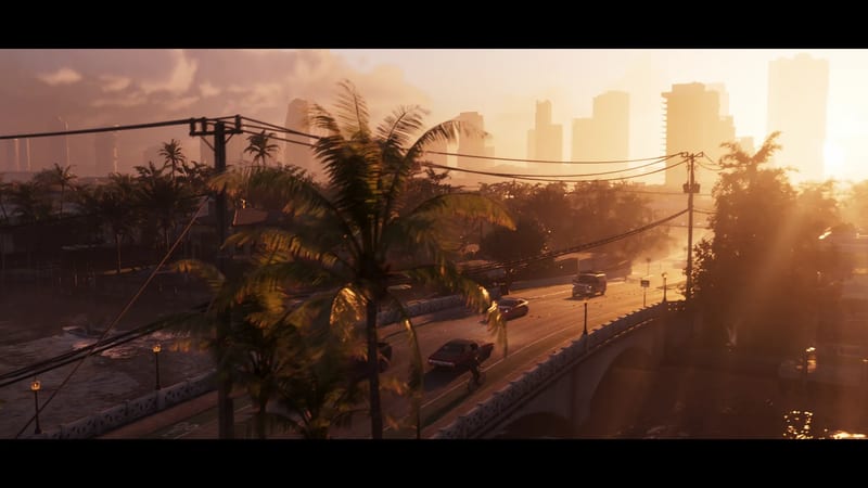 Cars and a cyclist cross a bridge at golden sunset in Vice City, with palm trees and hazy skyscrapers in the distance.
