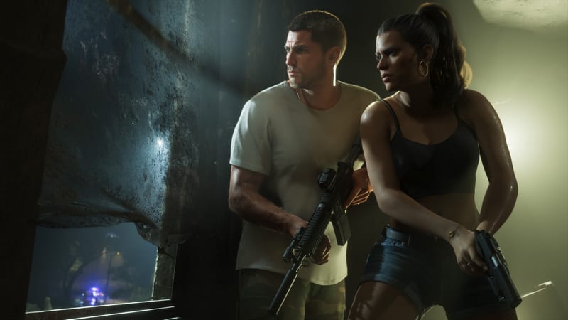 Jason Duval and Lucia Caminos crouch armed beside a dark, damaged window, watching police lights flash outside at night.