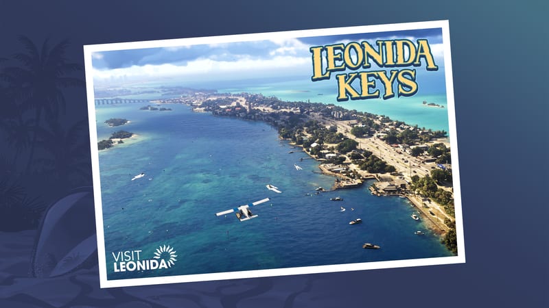 Aerial view of Leonida Keys, a long strip of land with a busy road, boats and a white seaplane over blue-green water, on a postcard.