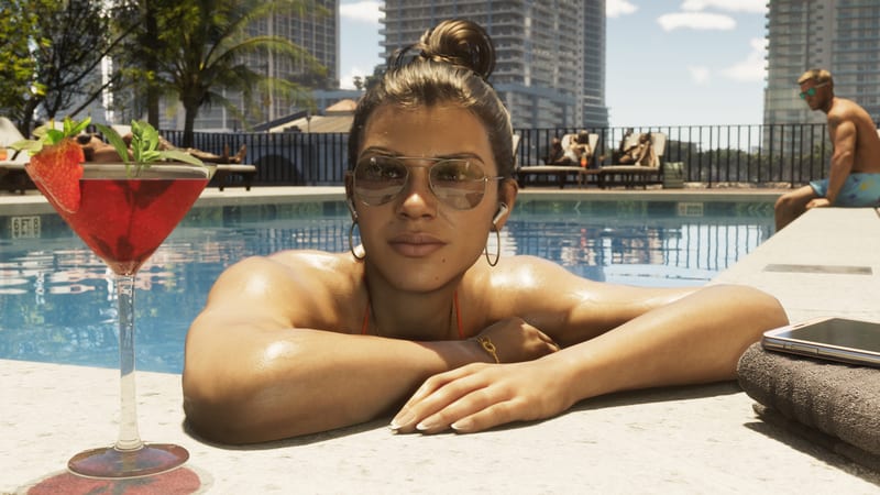 Lucia Caminos rests her arms on the edge of a rooftop pool, wearing aviator sunglasses, with a red cocktail beside her on a sunny day.
