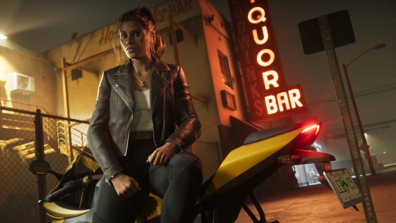 Lucia Caminos sits on a yellow motorbike in a leather jacket at night, beside a glowing neon "Liquor Bar" sign and a chain-link fence.