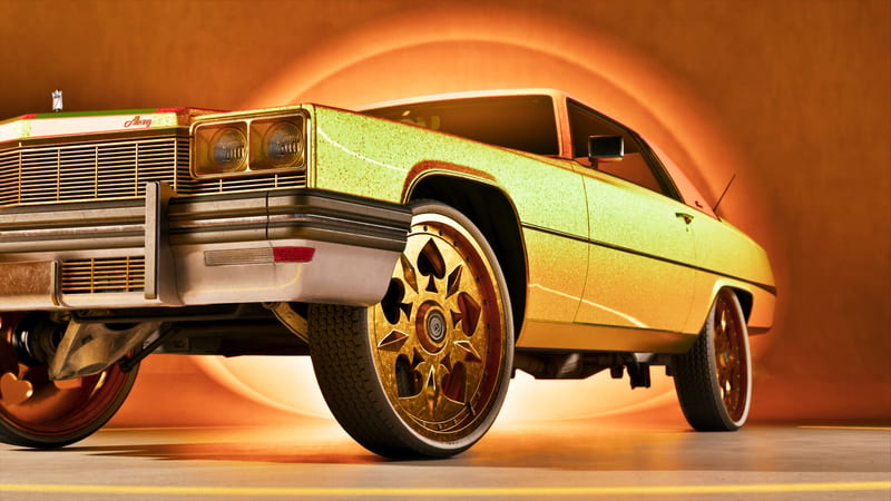 A glittering yellow-green classic coupe with gold spade-pattern wheels, seen from a low angle against a glowing orange circular backdrop.