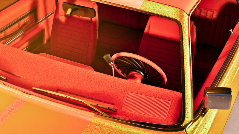 Looking down through the windscreen of a custom car with a red carpeted dashboard, red seats and a metallic yellow-green sparkle paint finish.