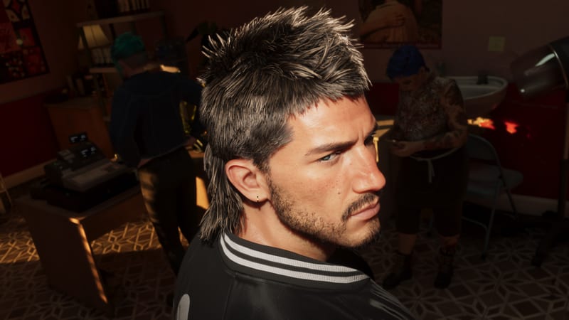 Jason Duval, a stubbled man with a spiky mullet, glances over his shoulder in a dimly lit salon with two people behind him.