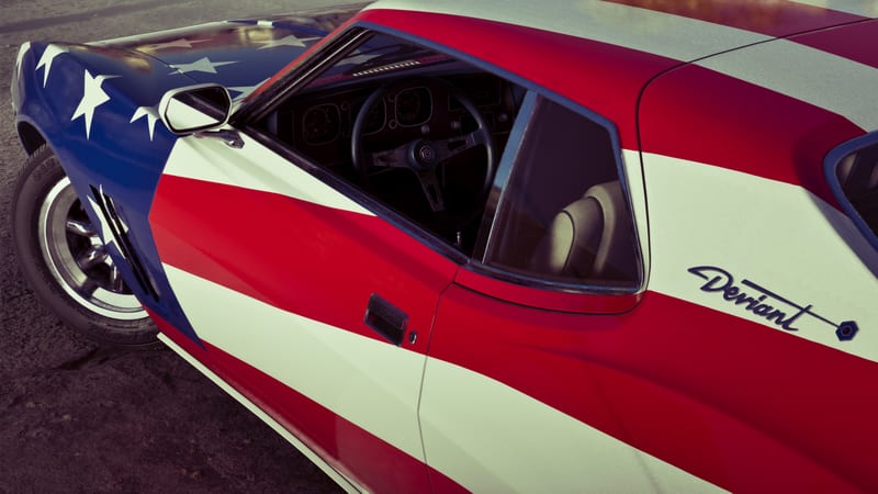 A Schyster Deviant painted in a stars and stripes design, seen from the front left, with its interior visible through the window.