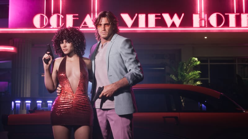 Lucia Caminos and Jason Duval stand holding pistols in front of the neon-lit Ocean View Hotel, with a red car behind them at night in Vice City.