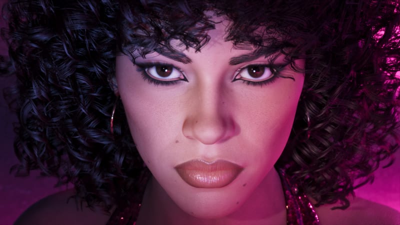 Close-up of a woman with voluminous curly dark hair, hoop earrings and dramatic eye makeup, lit in vivid pink and purple.